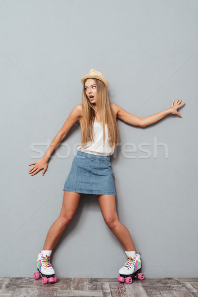 Stock photo: Funny cheerful girl in hat and roller skates having fun