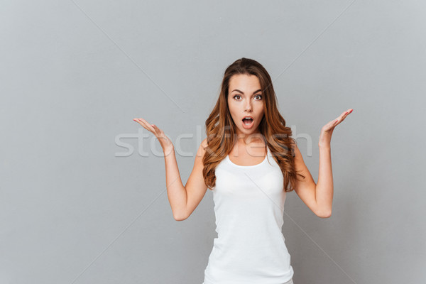 Portrait of surprised woman with mouth open standing Stock photo © deandrobot