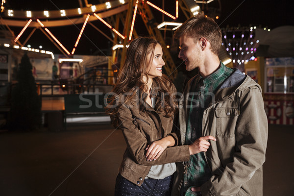Young cheerful couple in amusement park Stock photo © deandrobot
