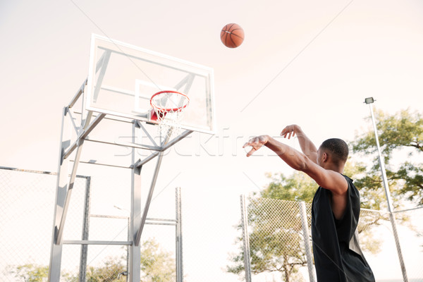 Attractive basketball player practicing in the street Stock photo © deandrobot