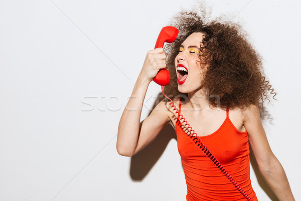 Szokatlan modell sikít telefonkagyló csukott szemmel izolált Stock fotó © deandrobot