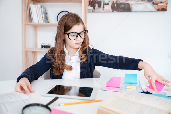 Little girl using blank screen tablet and colorful sticky notes Stock photo © deandrobot