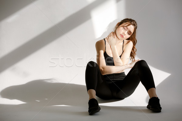 Sports woman resting after workout while sitting on the floor Stock photo © deandrobot