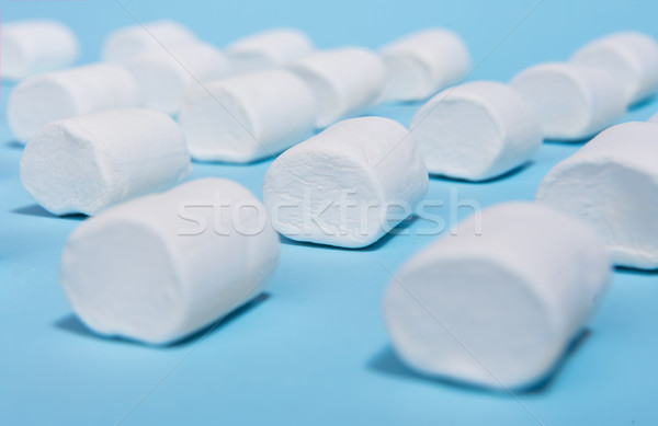 White sweeties marshmallows over blue table background. Stock photo © deandrobot