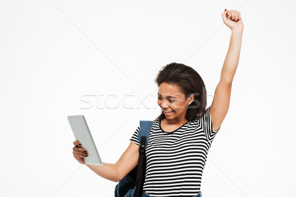 Happy afro american teenage girl with backpack holding pc Stock photo © deandrobot