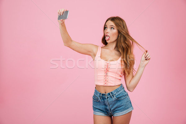 Portrait of a pretty young woman in summer clothes standing Stock photo © deandrobot