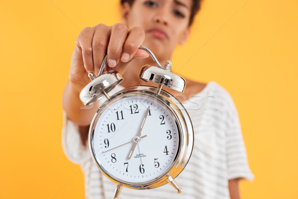 Close up of alarm clock in woman's hand isolated Stock photo © deandrobot