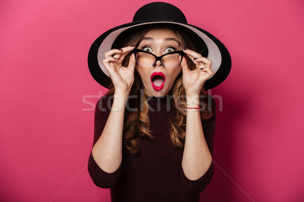 Shocked lady wearing hat and glasses Stock photo © deandrobot