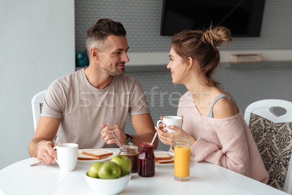 肖像 笑みを浮かべて 愛する カップル 朝食 座って ストックフォト © deandrobot