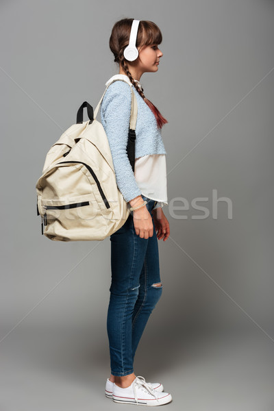 Side view photo of girl listening music with headphones Stock photo © deandrobot
