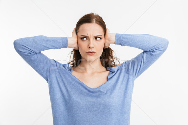 Portrait of a upset young woman covering ears Stock photo © deandrobot