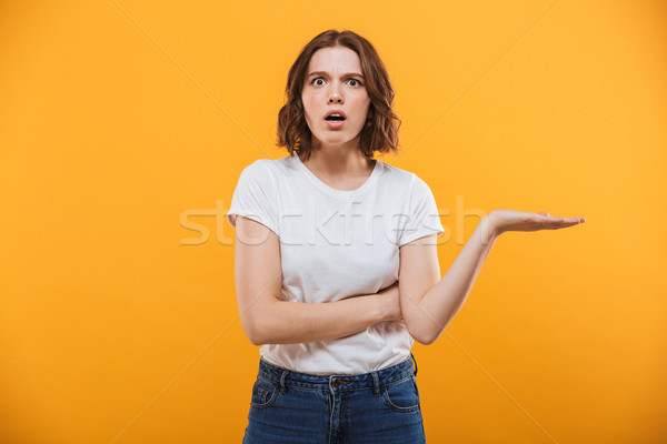 Displeased young lady standing isolated Stock photo © deandrobot