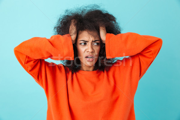 Image closeup of confused woman in red shirt looking aside and g Stock photo © deandrobot