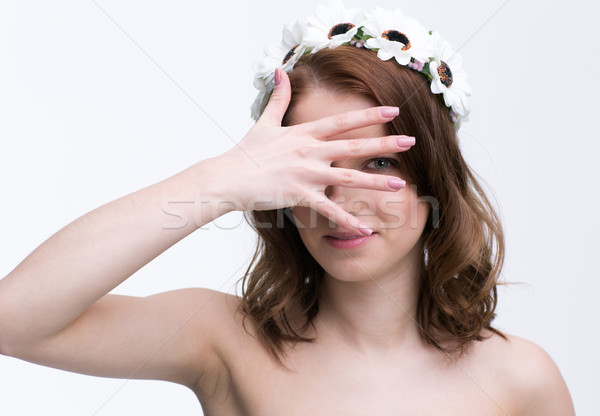 Beautiful woman covering her eyes with her hand Stock photo © deandrobot