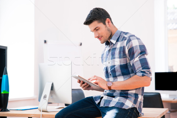Businessman in casual cloth using tablet computer Stock photo © deandrobot