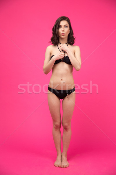 étonné jeune femme bikini posant rose regarder [[stock_photo]] © deandrobot