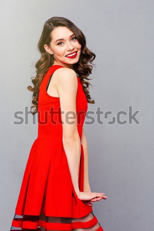 Portré csinos nő szoknya mosolyog áll szürke Stock fotó © deandrobot