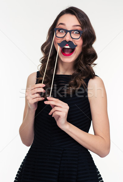 Funny cheerful woman having fun using glasses and moustache props  Stock photo © deandrobot