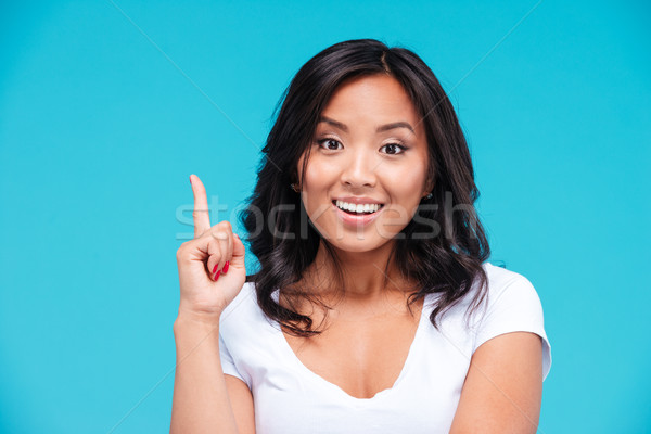 Happy inspired vietnamese woman pointing up and having an idea Stock photo © deandrobot