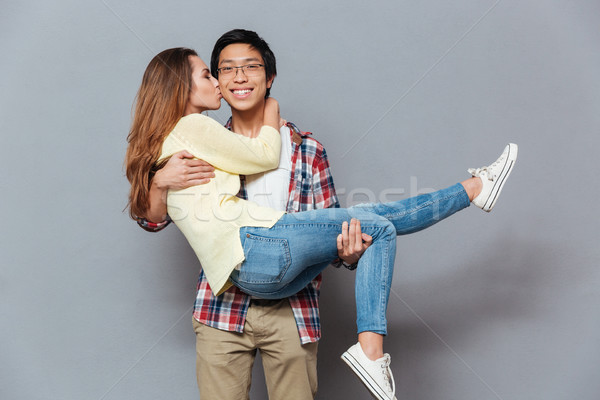Happy couple having fun and kissing Stock photo © deandrobot
