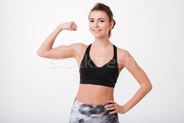 Fiatal fitnessz hölgy mutat bicepsz fotó Stock fotó © deandrobot