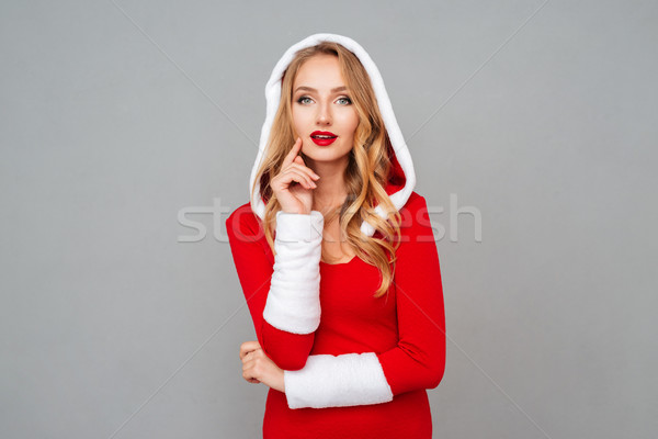 Beautiful young woman in red new year costume with hood Stock photo © deandrobot
