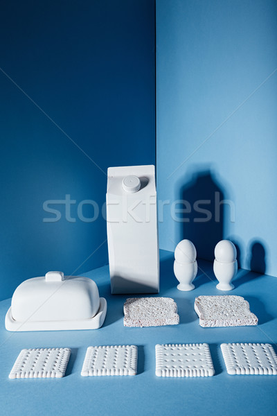 White pack of milk, eggs, butter, cookies and bread slices Stock photo © deandrobot