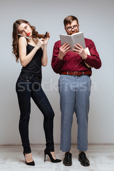 Vertical image of Woman talking on phone near male nerd Stock photo © deandrobot