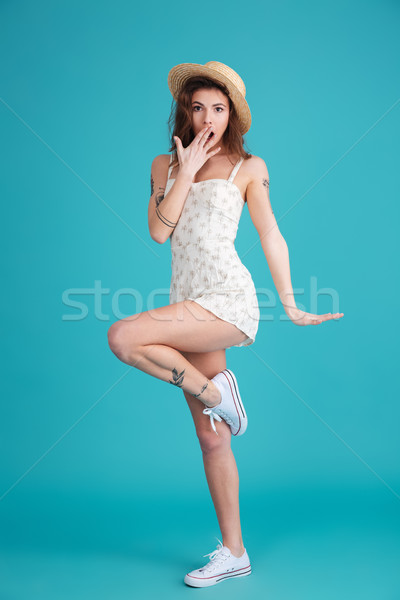 Full length portrait of a happy cheerful woman wearing hat Stock photo © deandrobot