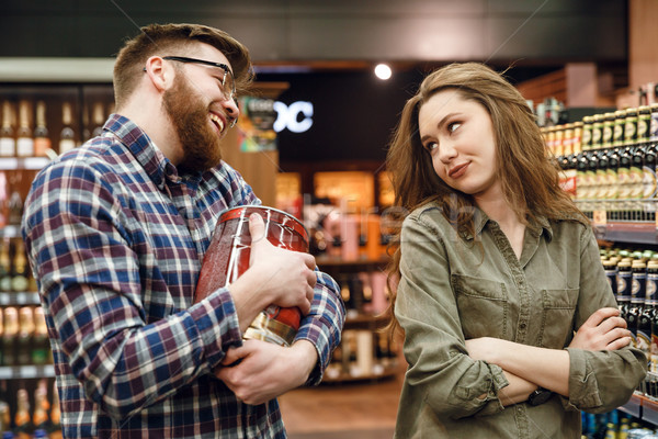Man wants to by keg of beer but woman against Stock photo © deandrobot