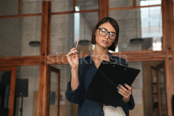 Pretty business woman in eyeglasses Stock photo © deandrobot