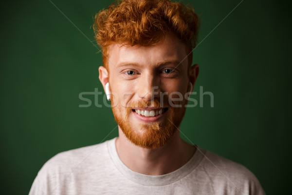 Close-up portrait of smiling curly redhead man, listening to mus Stock photo © deandrobot