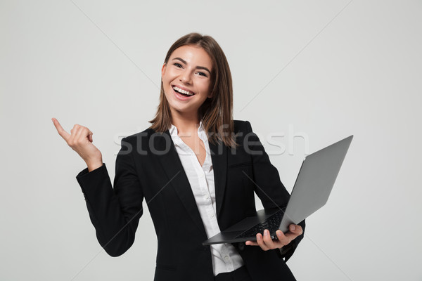 Portré boldog optimista üzletasszony öltöny tart Stock fotó © deandrobot