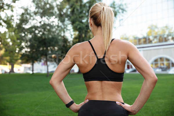 Back view picture of amazing strong young sports woman Stock photo © deandrobot