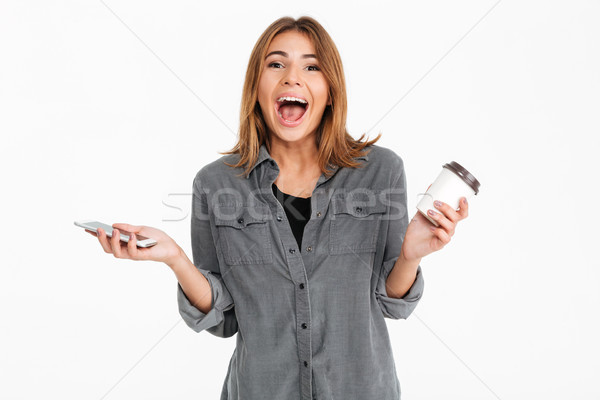 Сток-фото: портрет · возбужденный · счастливая · девушка · мобильного · телефона · питьевой