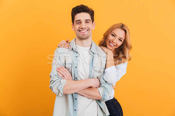Stock photo: Portrait of loving couple man and woman in basic clothing lookin