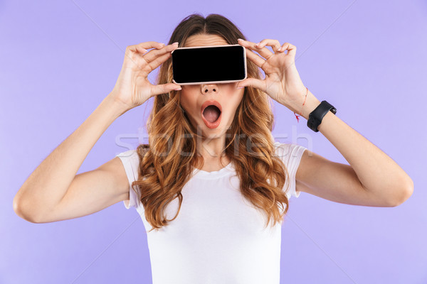 Close up of a shocked young girl standing Stock photo © deandrobot