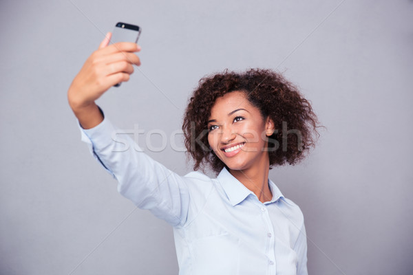 Smiling afro american woman making selfie photo Stock photo © deandrobot