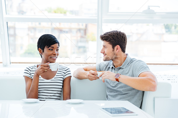 Happy couple drinking coffee and having good time in cafe Stock photo © deandrobot