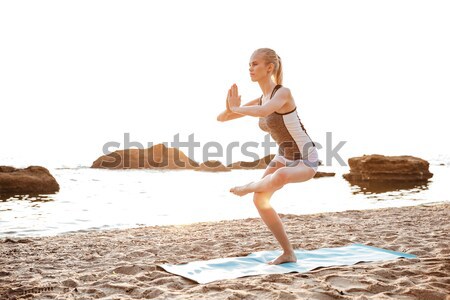Fiatal nő áll jóga póz egy láb portré Stock fotó © deandrobot