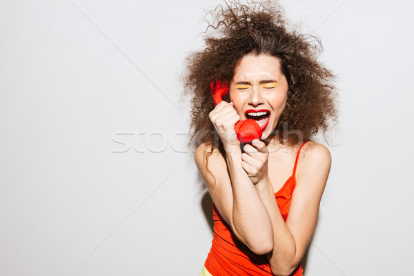 Upset Unusual model screaming at handset Stock photo © deandrobot