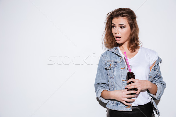 Young lady drinking aerated sweet water. Stock photo © deandrobot