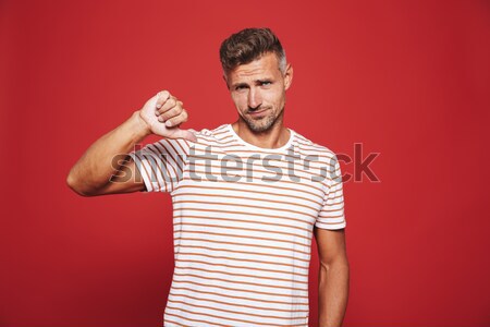 Handsome confident man in plaid shirt taking selfie on smartphone Stock photo © deandrobot