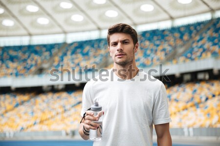 Handsome young sports man at the stadium outdoors Stock photo © deandrobot