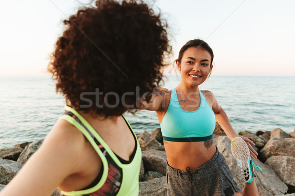 Close up image of two pretty women warming up outdoors Stock photo © deandrobot