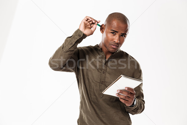 Figyelmes fiatal afrikai férfi ír jegyzetek Stock fotó © deandrobot