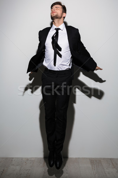Teljes alakos portré fiatal üzletember csukott szemmel ugrik Stock fotó © deandrobot
