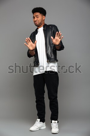 Full length photo of young displeased african guy swoving stop g Stock photo © deandrobot