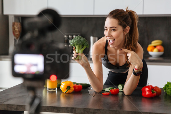 Happy healthy young girl recording her blog episode Stock photo © deandrobot