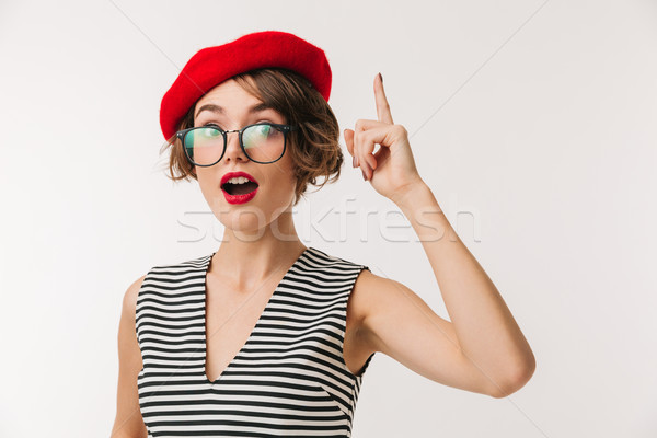 Portrait of an excited woman wearing red beret pointing Stock photo © deandrobot